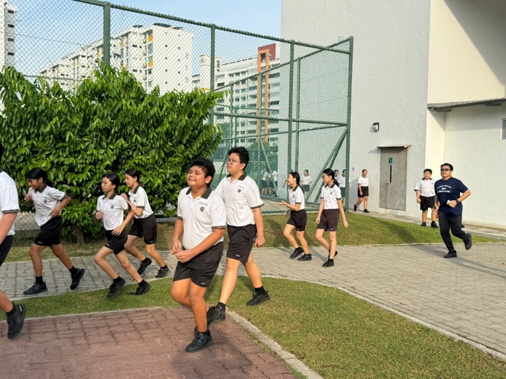 Students running alongside their peers