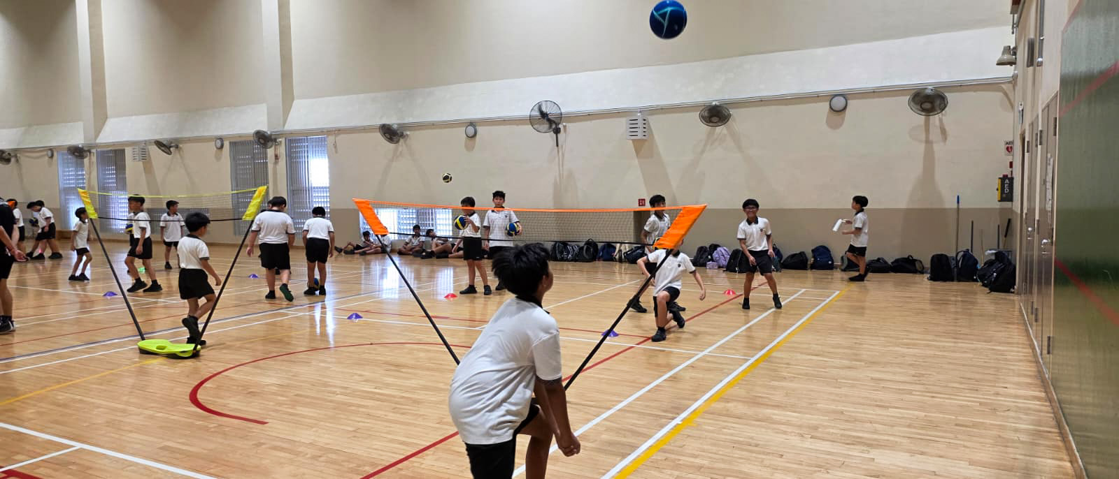 Students applying the skills they have learnt in a modified volleyball game